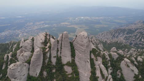 montserrat nature park mountain top with the view of barcelona city under grey polluted sky due to climate change, spain