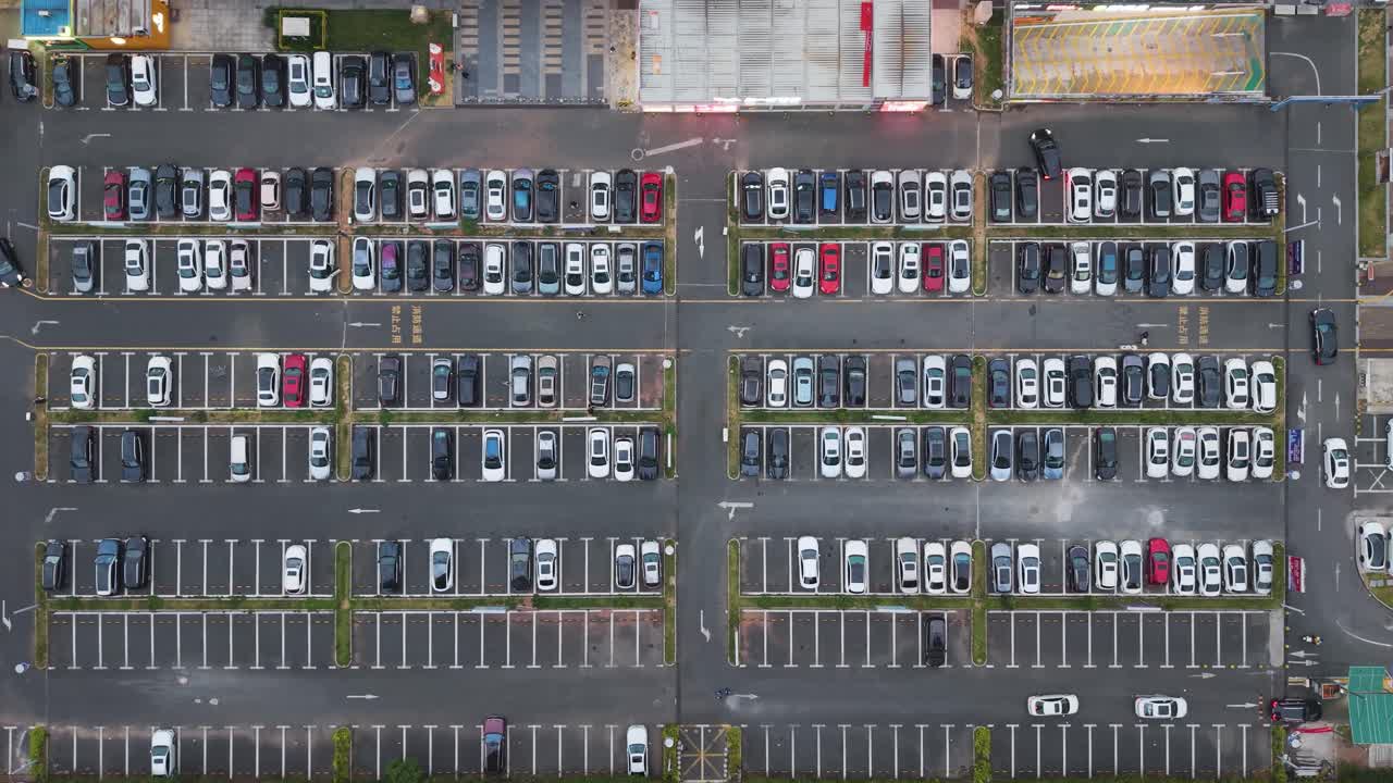 Aerial top-down view of a busy car park in Shenzhen’s Pingshan District, showing organized parking rows, vehicles, and urban surroundings in daylight