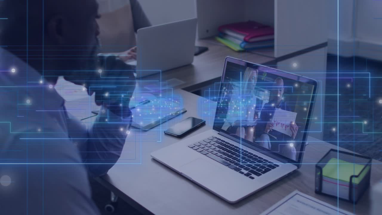 Man watching laptop as presenter starting business meeting, holographic overlay highlighting phone