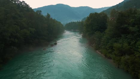 soča isonzo river with its iconic emerald blue water in the alps in slovenia and italy