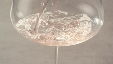 orange or white wine bottle and glass against a sunset in a peaceful vineyard, pouring of ecological natural wine.