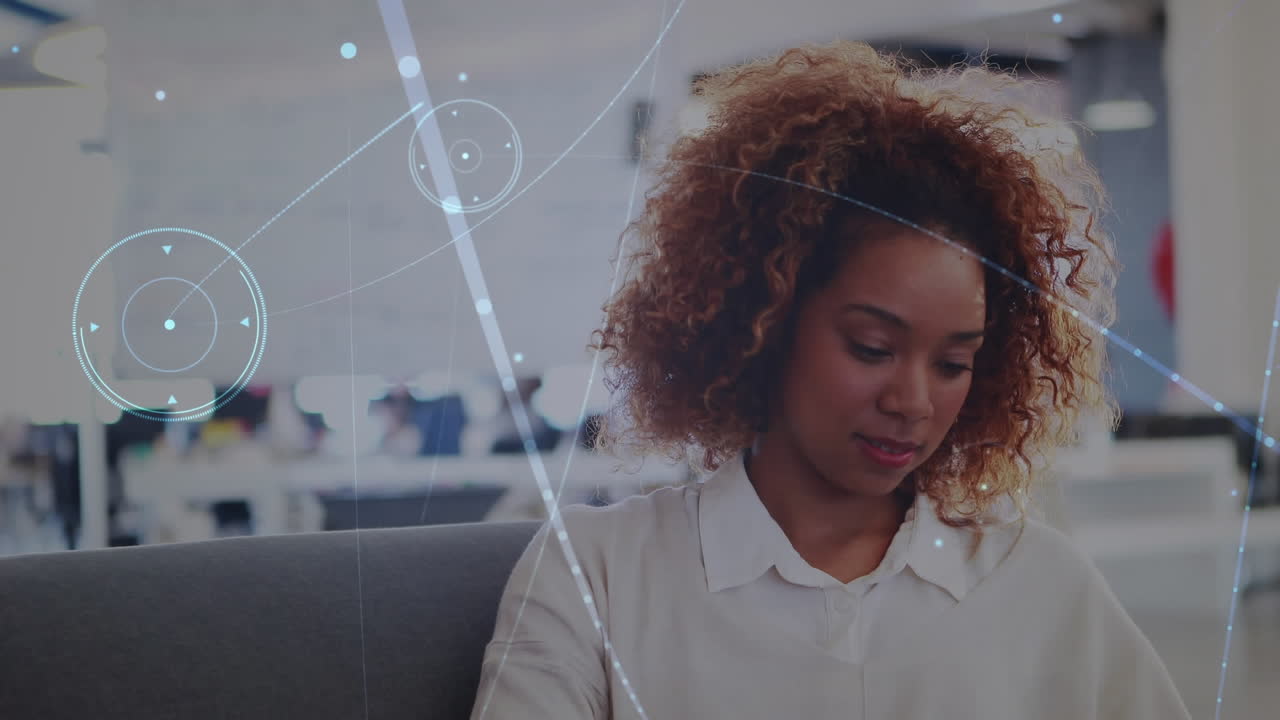 Animation of network of connections against african american woman using smartphone at office