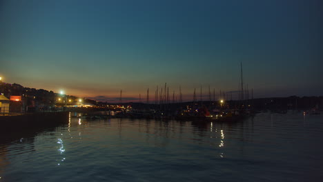 boats moored in the falmouth harbour at night in cornwall, england, united kingdom