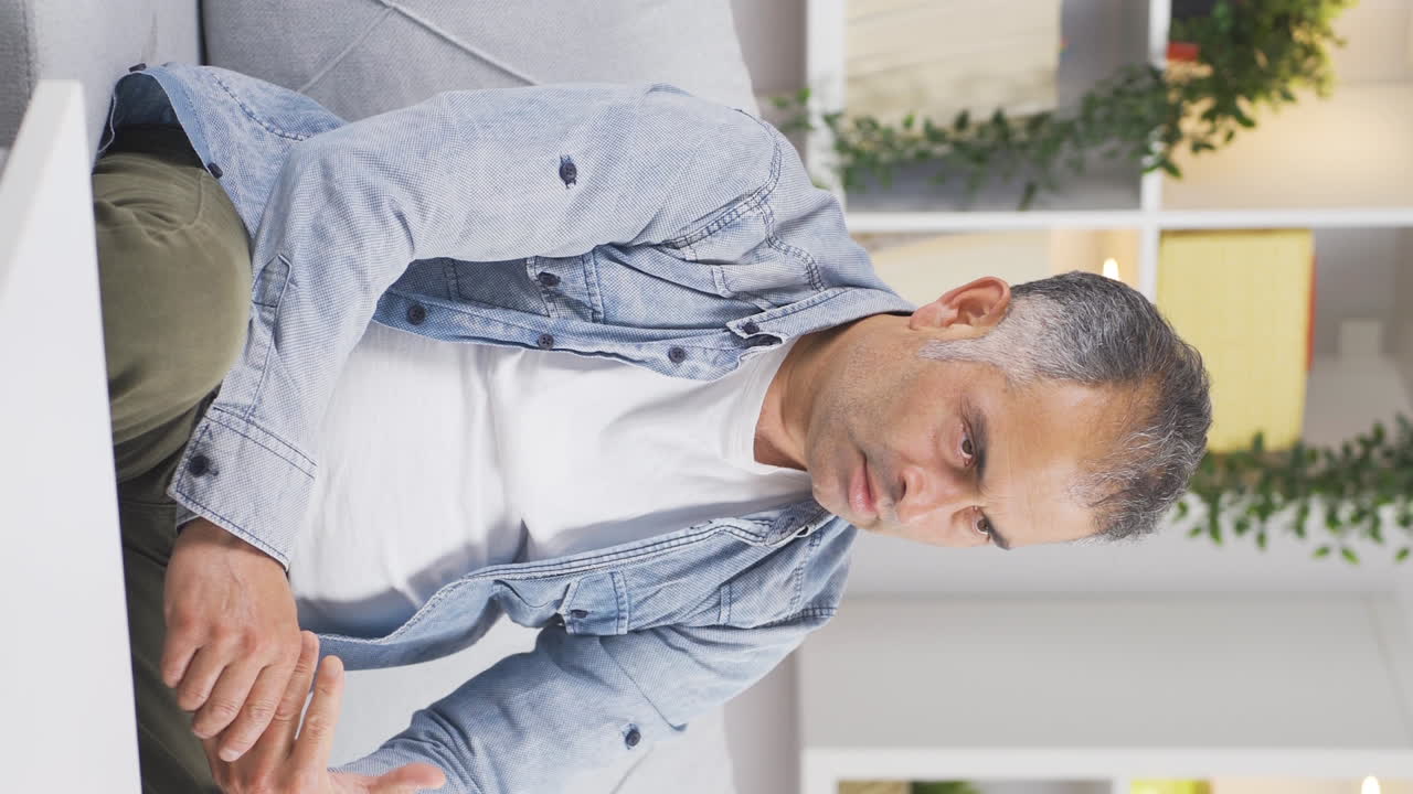 Vertical video of The cheated man takes off the ring and throws it away.