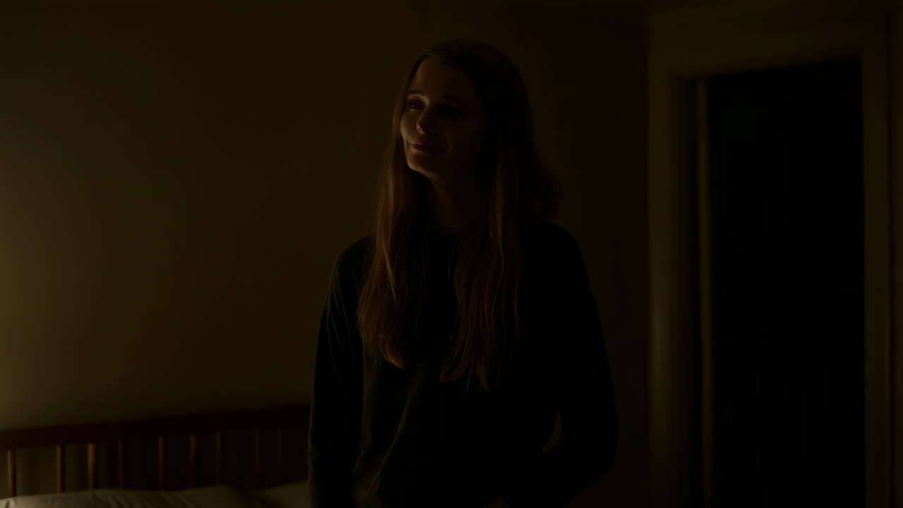 Young Woman in a Dimly Lit Bedroom