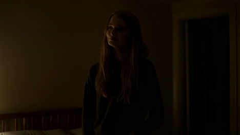 Young Woman in a Dimly Lit Bedroom