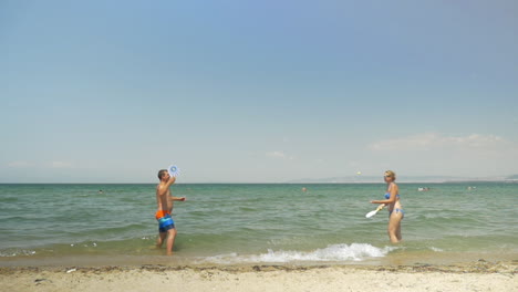 couple playing ping pong on the beach