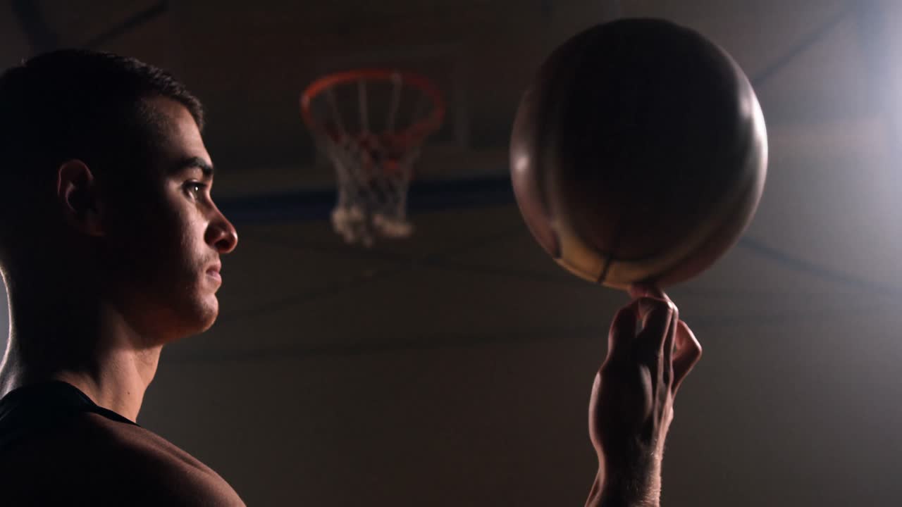 deportista girando el baloncesto en el dedo