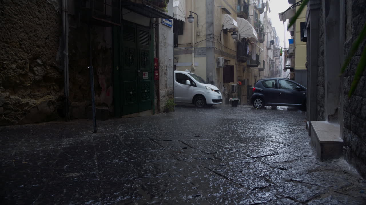 Heavy Rain Falling on a Wet Cobblestone Street in an Old European City