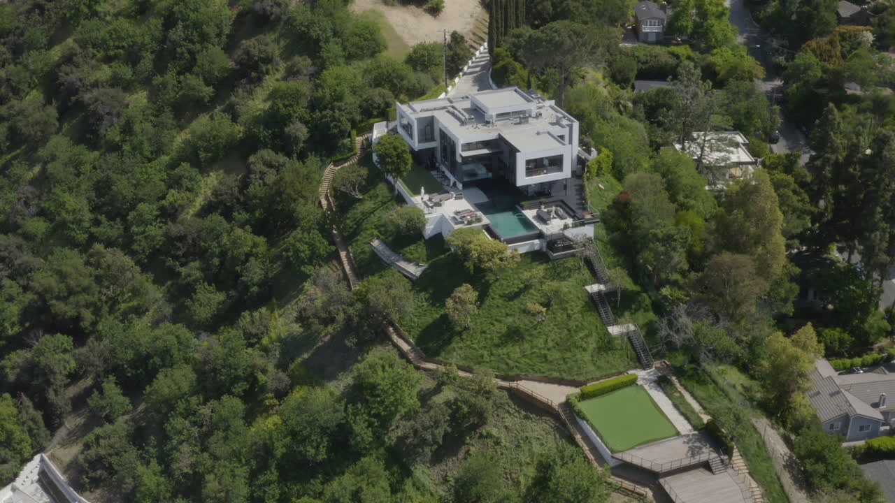 4K aerial of a modern mansion on a hill in Studio City California.