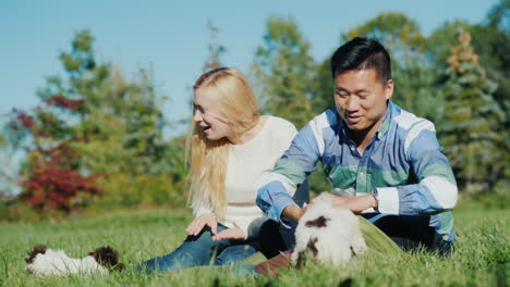 Man-and-Woman-Play-With-Puppies