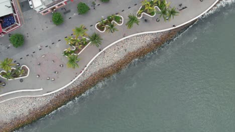 aerial: pier with rocks and people