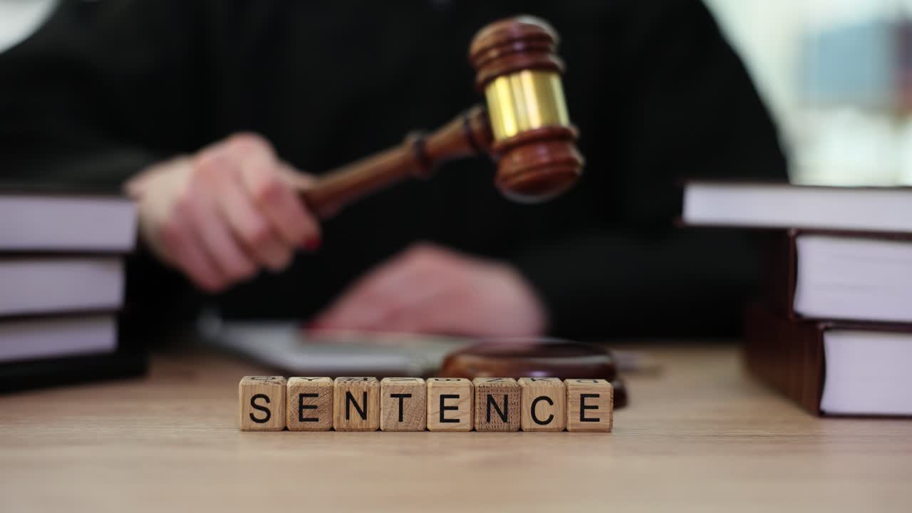Judge with Gavel and Sentence Blocks on a Desk