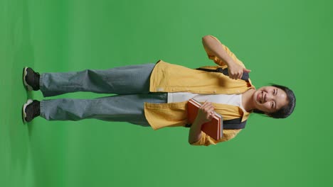 student with books and backpack