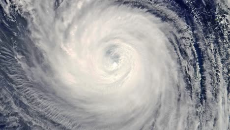 satellite view over the eye of a hurricane as it rotates continuously