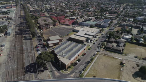 Static-perspective-of-aerial-view-looking-up-v-shaped-intersection-meeting-at-a-round-about-below