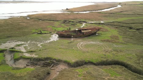 rusty shipwreck orbit on salt marsh at fleetwood marshes nature reserve