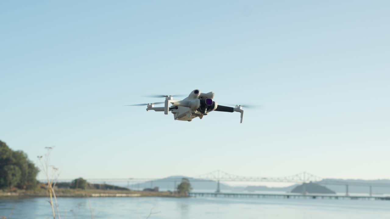 A compact drone floats above the beach while the Richmond–San Rafael Bridge frames the upper edge of the scene, uniting coastal calm with quiet flight