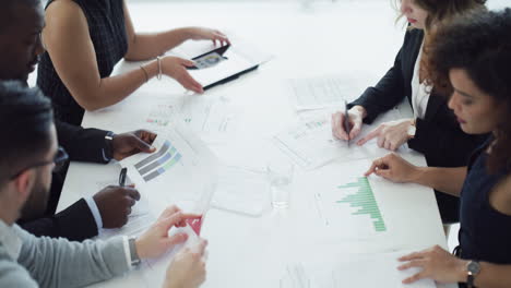 a group of businesspeople using a digital tablet