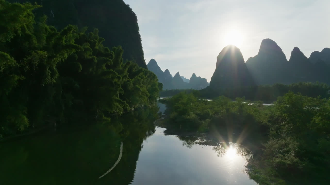Aerial view over reflecting waters, revealing rafts on Li river, in Yangshuo