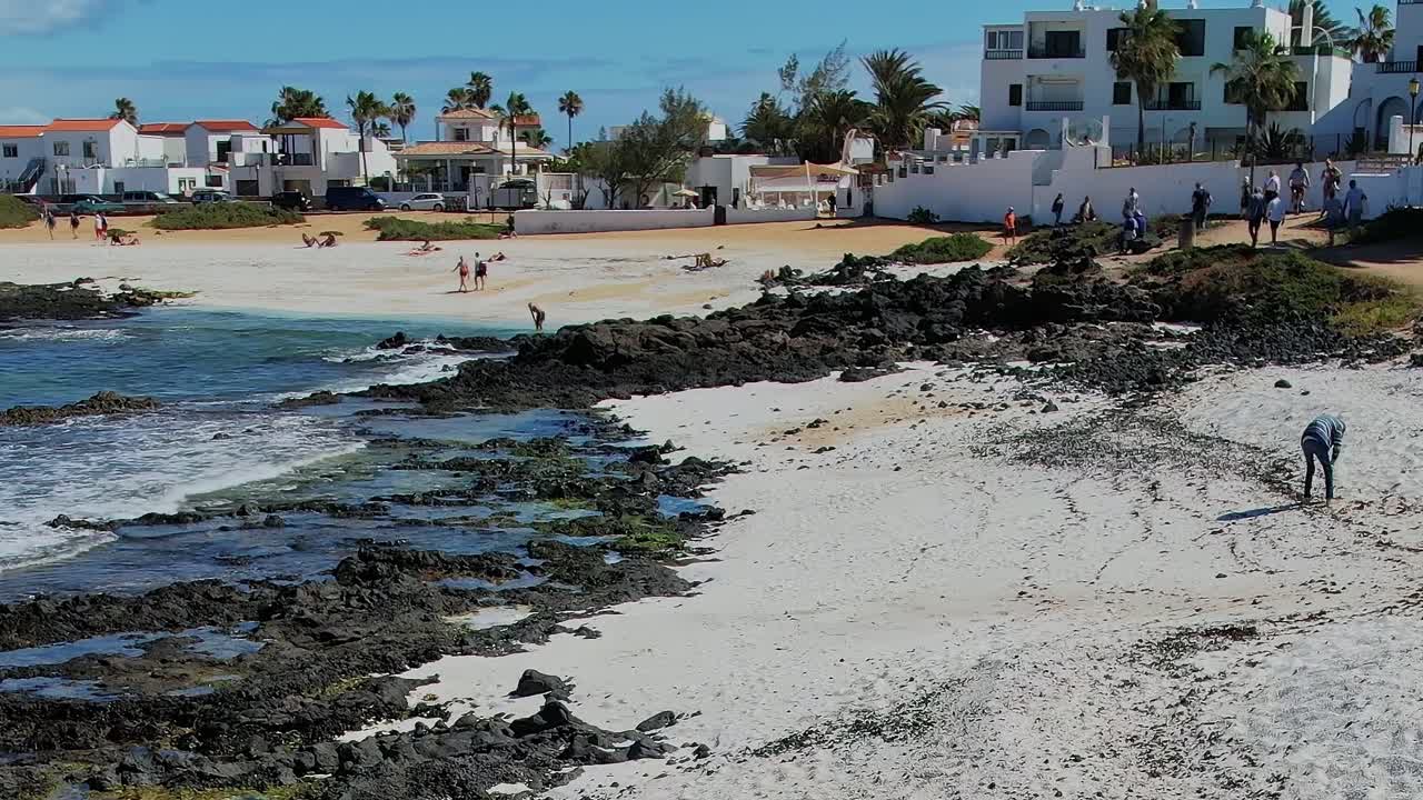 Besøkende nyter en solrik dag på stranden på Kanariøyene, Spania