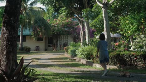 Rear-Of-A-Young-Teenager-Woman-Walking-At-The-Garden-Yard