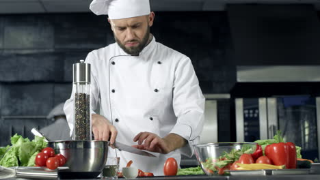 professional chef cooking salad in restaurant kitchen