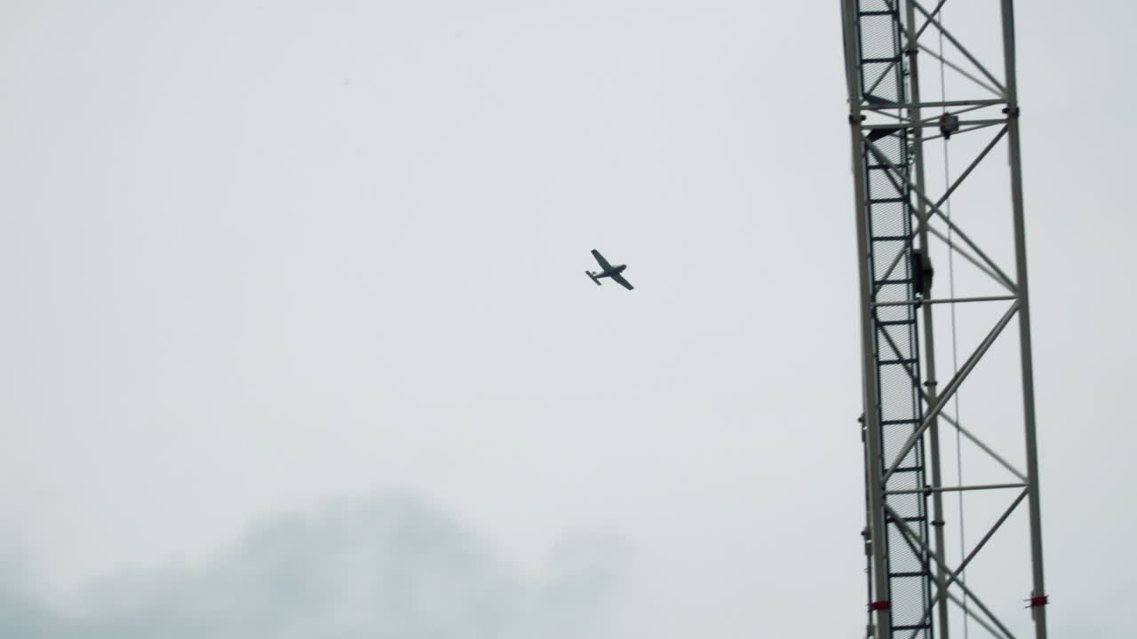 Airplane Flying High On The Sky And Over The Skyscrapers. wide shot