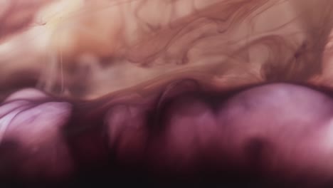 Slow-motion-video-of-purple-watercolor-ink-mixed-in-water-against-black-background