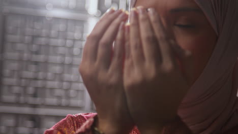 Studio-Head-And-Shoulders-Portrait-Of-Muslim-Woman-Wearing-Hijab-Praying-In-Mosque-Or-At-Home-1