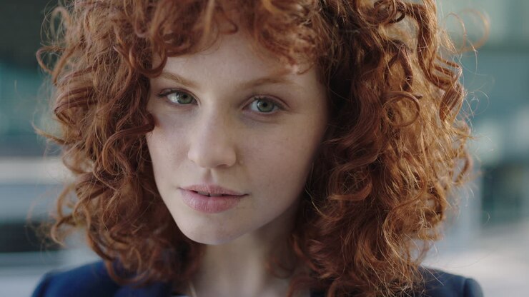 portrait of young beautiful red head business woman smiling portrait