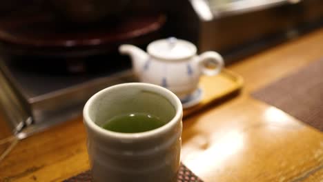 sequential tea pouring into a ceramic cup