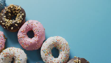 video of donuts with icing on blue background