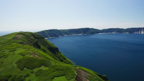 awesome circle panorama. wide shoreline by blue water lagoon, green hills around