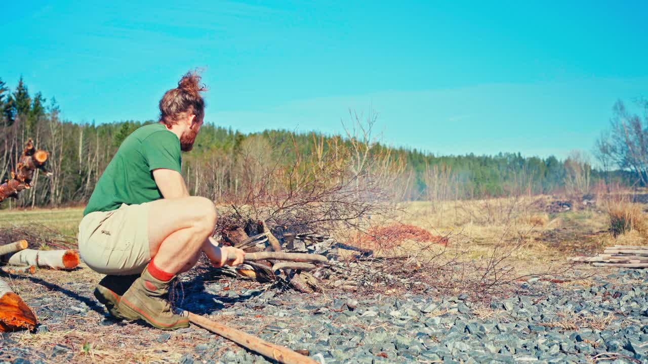 Man Pulling Poles For Firewood - Wide Shot