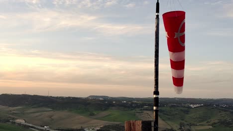 Hand-held-shot-of-a-striped-windsock-showing-the-change-of-direction-in-the-wind