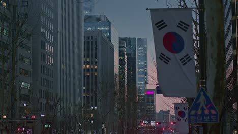 south korea seoul gangnam night city town urban street view with flags, buildings, constructions and skyscrapers in the sunset