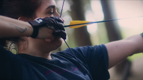 Archery-woman-pulls-and-shoots-her-bow-close-shot