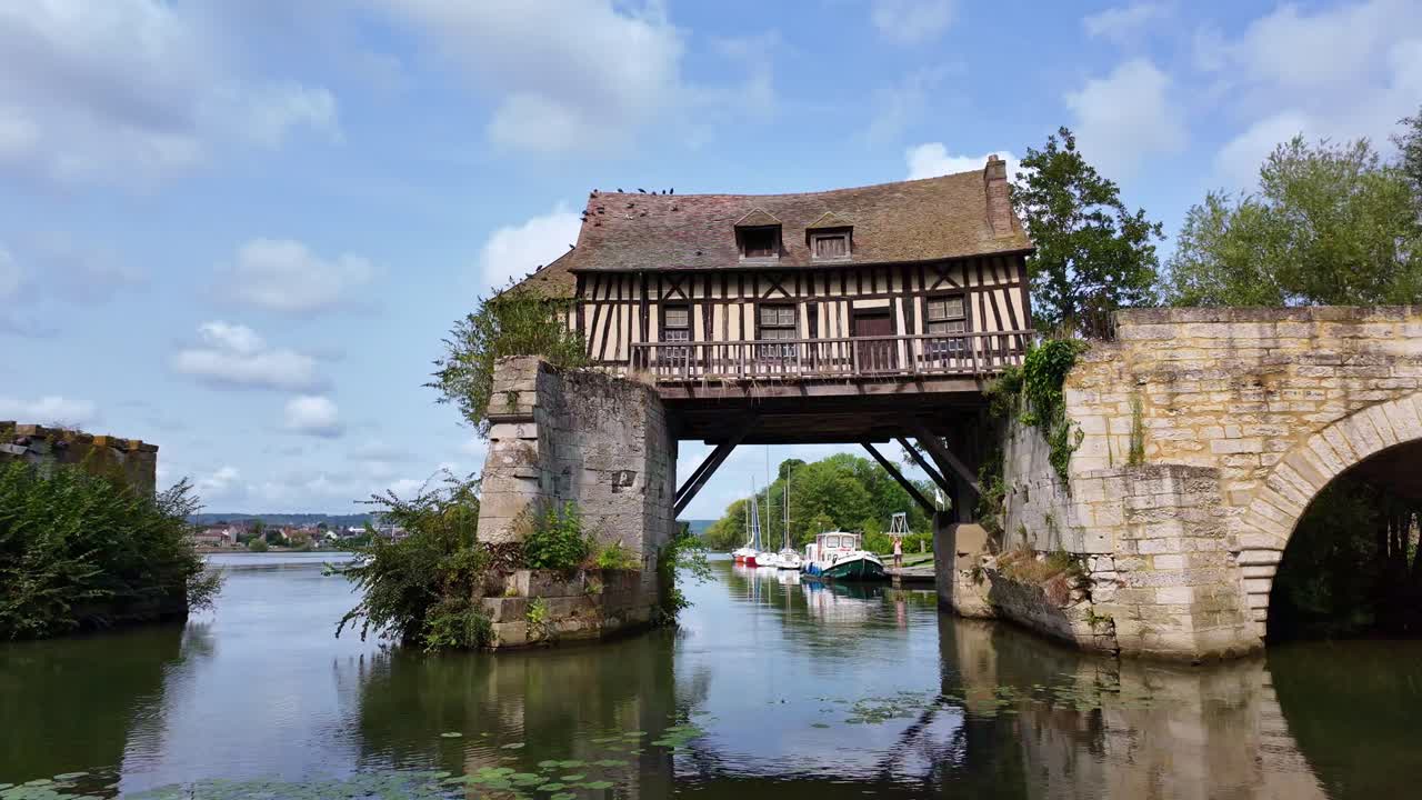 View of the iconic old mill in the town of Vernon, France. Panning
