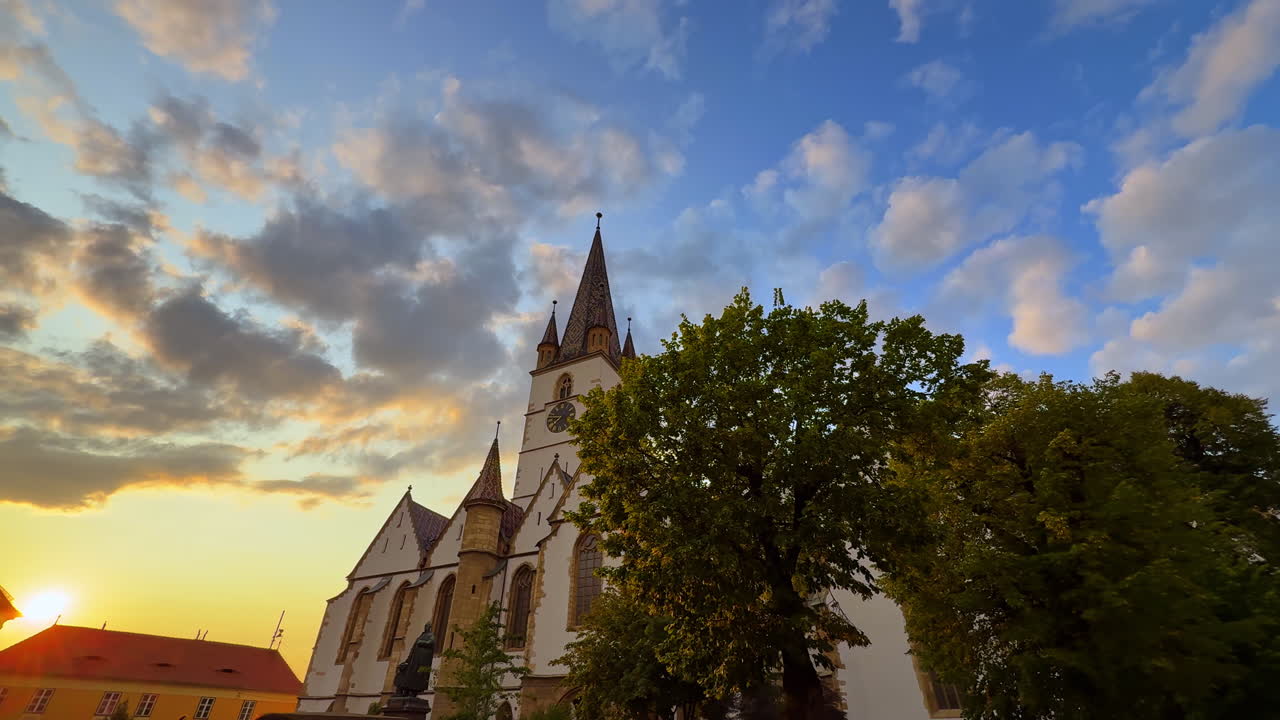 Sibiu, Romania, 1 July 2025: Sunset view of the Evangelical Cathedral in Sibiu. Romanian Evangelical Cathedral with Gothic towers at sunset in Sibiu, Romania