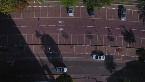 aerial view of a parking lot with cars and people