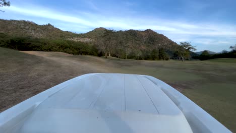 golf cart driving through scenic golf course