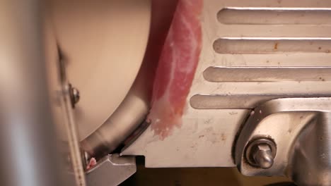 hand slice raw meat with slicer, close up