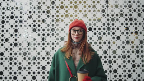 woman with coffee in winter city