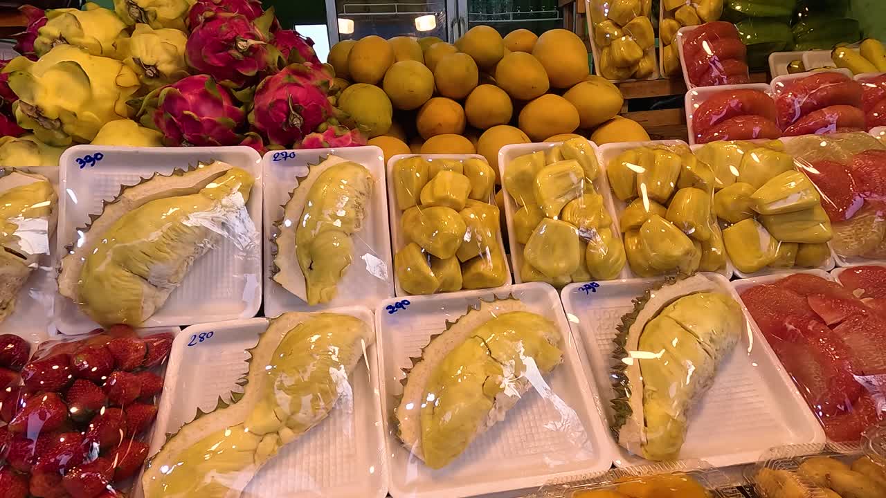 Colorful tropical fruits beautifully arranged for sale