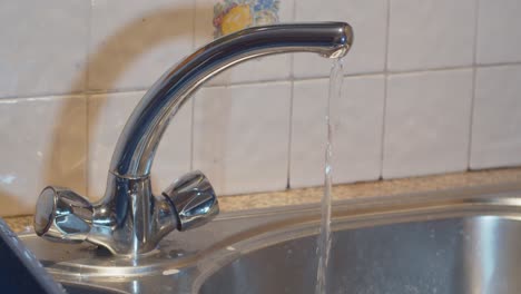 household water tap running in slow motion