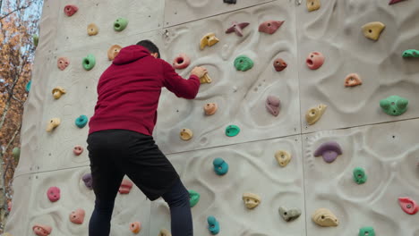 man climber climbs a climbing wall without insurance - cinematic parallax shot