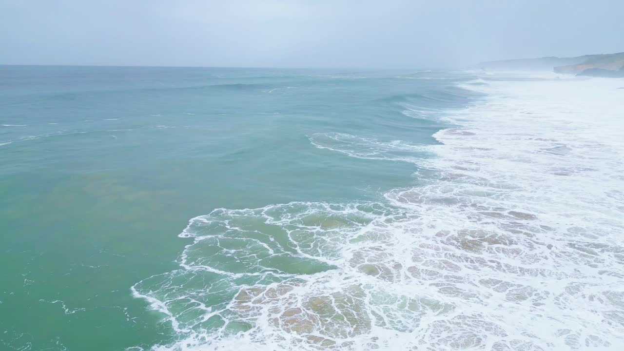 Waves crashing on remote Aljezur coast, tranquil and wild ocean scenery