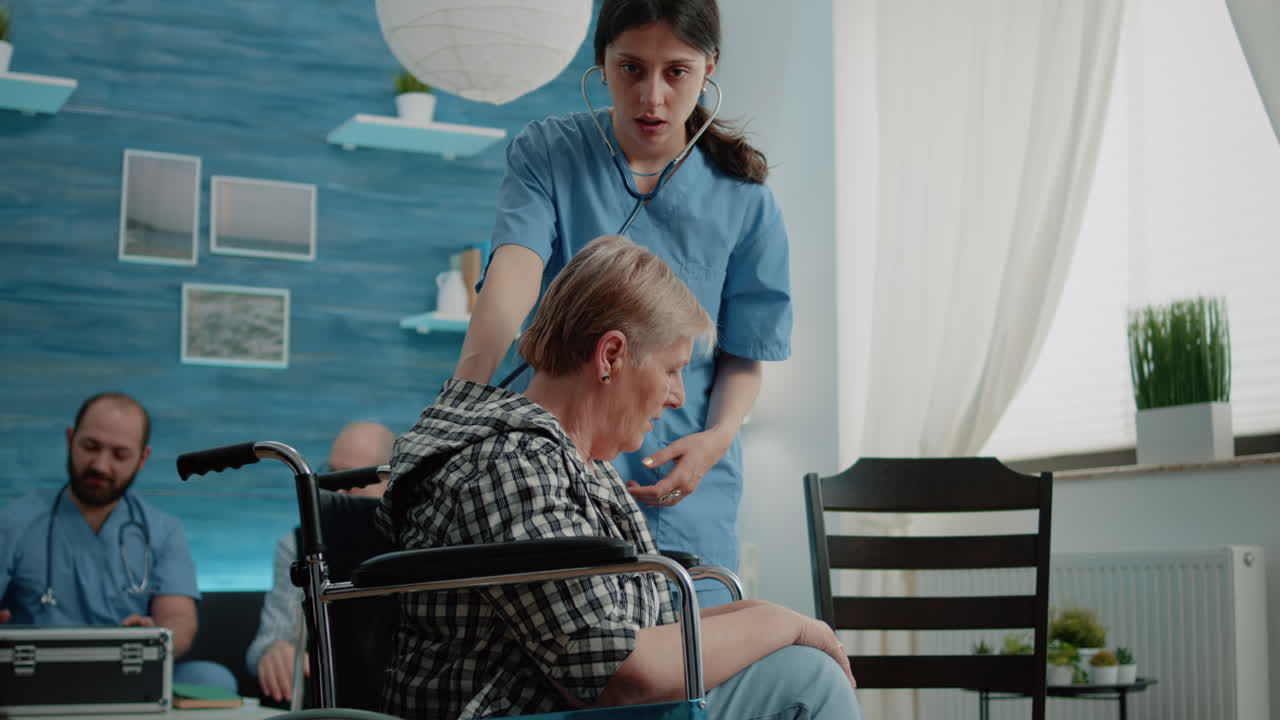 Nurse using stethoscope for heartbeat checkup on disabled woman