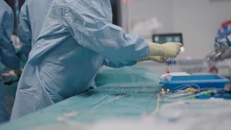 side view of doctor cleaning vascular stent from blood at french hospital